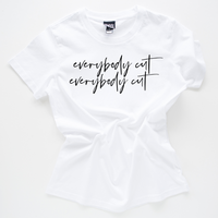 White slogan tee on a white background. Slogan says everybody cut as a reference to the 80s movie footloose. Tee is crumpled up in the centre