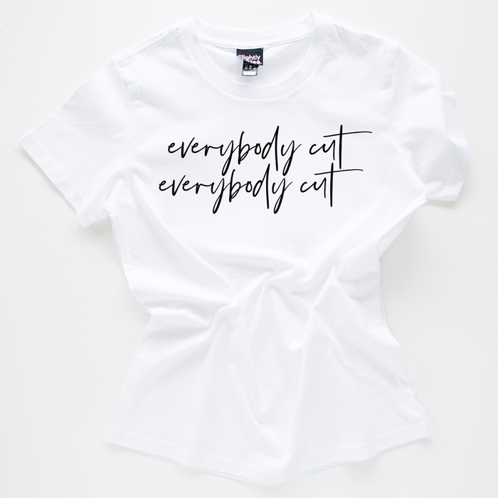 White slogan tee on a white background. Slogan says everybody cut as a reference to the 80s movie footloose. Tee is crumpled up in the centre