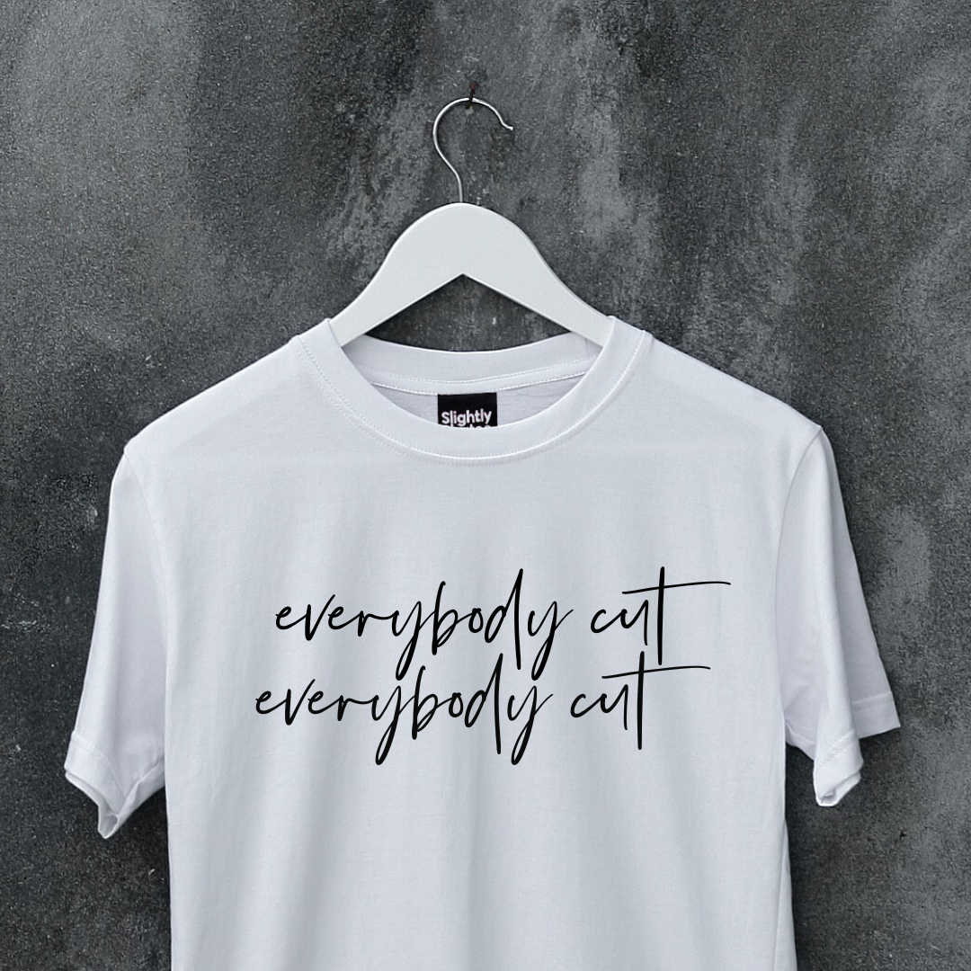 White slogan tee on a hanger. Slogan says everybody cut as a reference to the 80s movie footloos