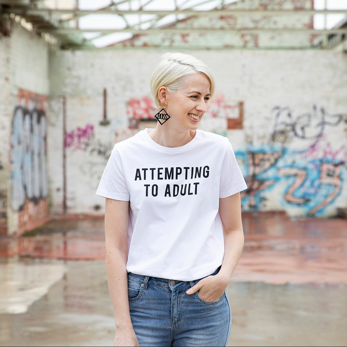 Slightly Shirtee Attempting to Adult Slogan White Tshirt worn by woman with blonde hair wearing denim jeans